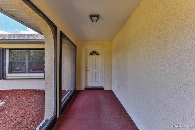 entrance to property with stucco siding