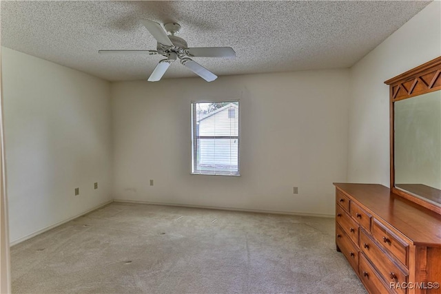5618 W Hesse Ct, Homosassa, FL 34448 - unfurnished room with a textured ceiling, baseboards, a ceiling fan, and light colored carpet