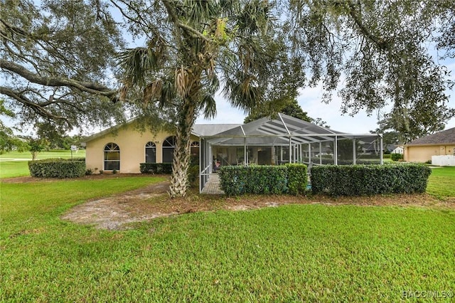 640 E Hartford St, Hernando, FL 34442 - back of property with a lawn, stucco siding, and glass enclosure