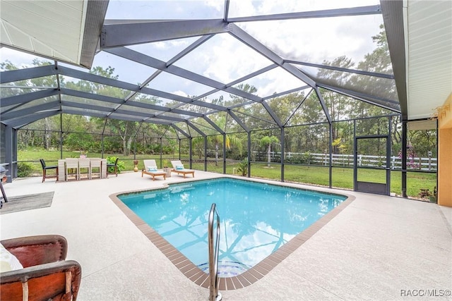 view of pool with glass enclosure, a patio area, and a yard