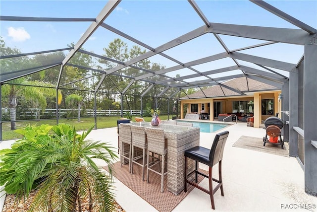 view of patio / terrace featuring a lanai and exterior bar