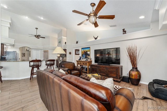 living room with ceiling fan and lofted ceiling