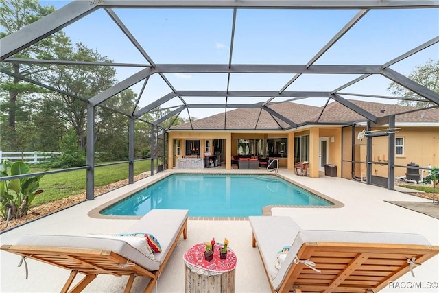 view of pool with glass enclosure, an outdoor living space, and a patio