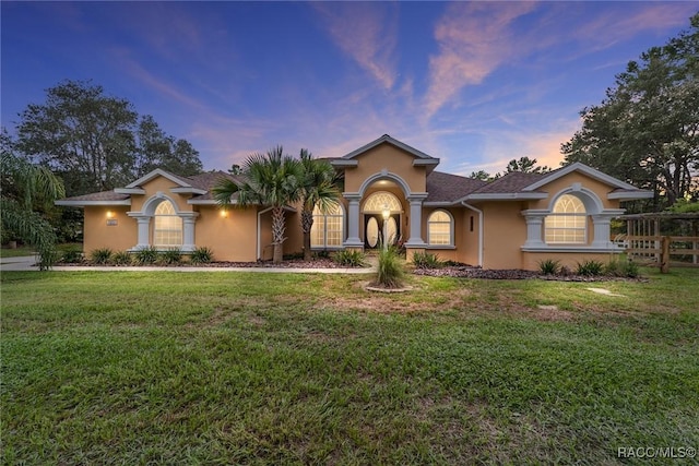 mediterranean / spanish-style house featuring a lawn