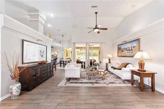 living room with ceiling fan and high vaulted ceiling