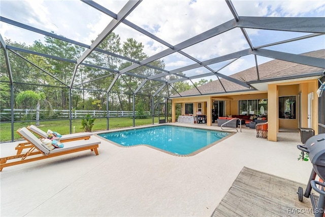 view of swimming pool with an outdoor living space, a patio area, and glass enclosure