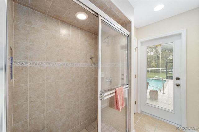 bathroom featuring tile patterned flooring and a shower with shower door