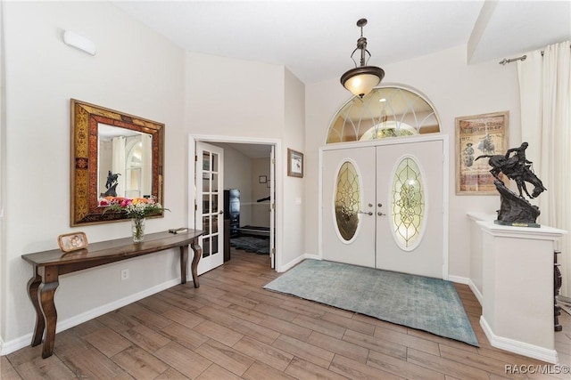 entryway featuring french doors and light wood-type flooring