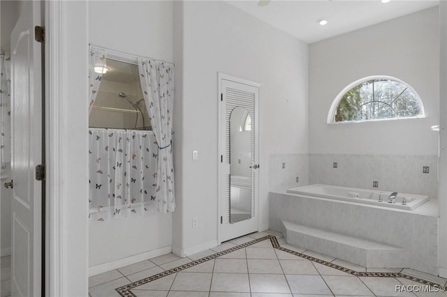 bathroom featuring tile patterned flooring and tiled tub