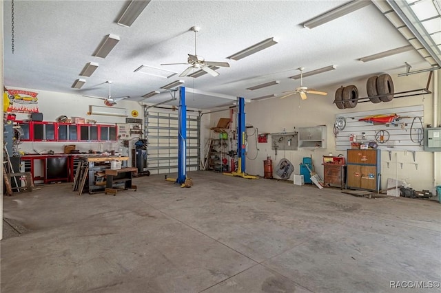 garage with ceiling fan, electric panel, and a workshop area