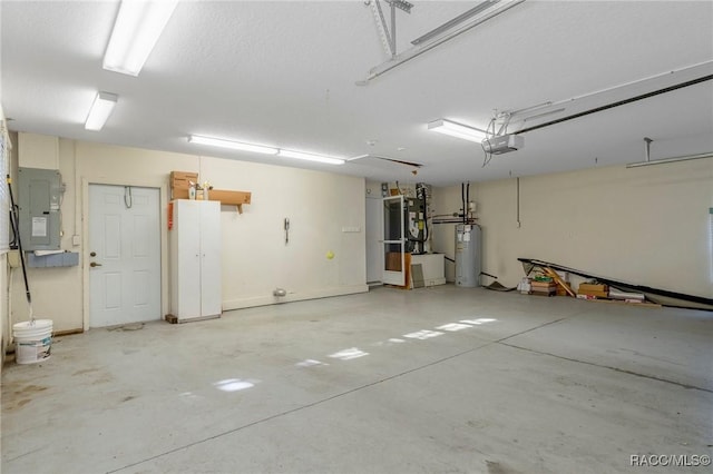 garage with a garage door opener, electric panel, and water heater