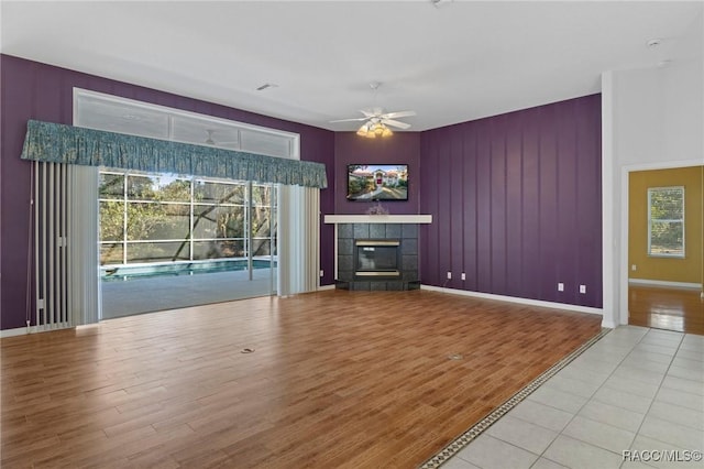 unfurnished living room featuring ceiling fan, light hardwood / wood-style floors, and a healthy amount of sunlight