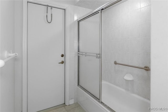 bathroom featuring tile patterned floors and combined bath / shower with glass door