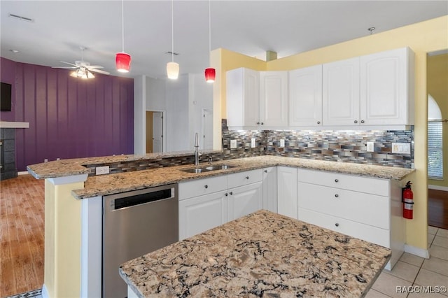 kitchen featuring dishwasher, decorative backsplash, white cabinets, and sink