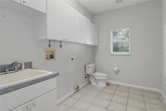 bathroom with tile patterned flooring, vanity, and toilet