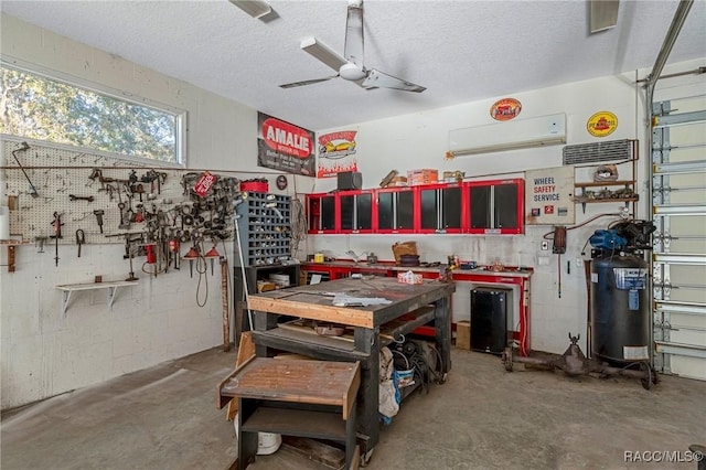 garage featuring ceiling fan and a workshop area