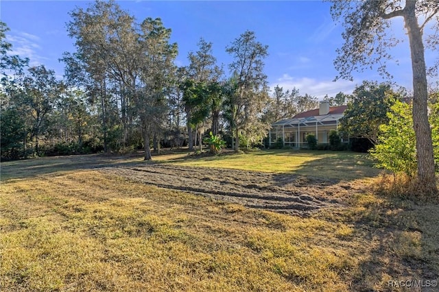 view of yard with a lanai