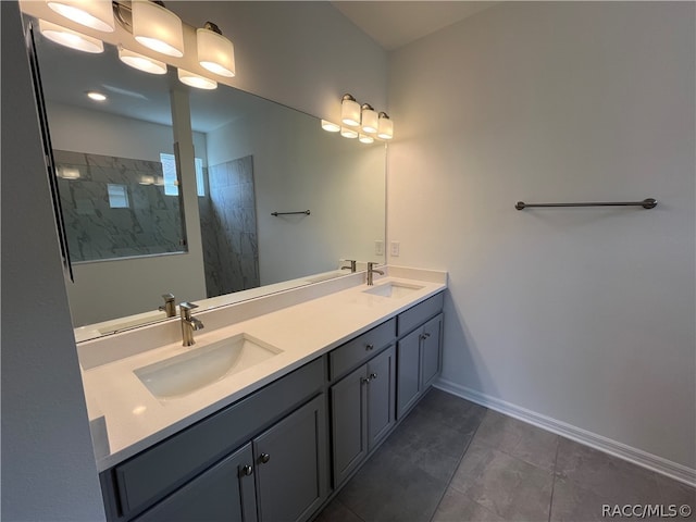 bathroom featuring tile patterned flooring, vanity, and tiled shower