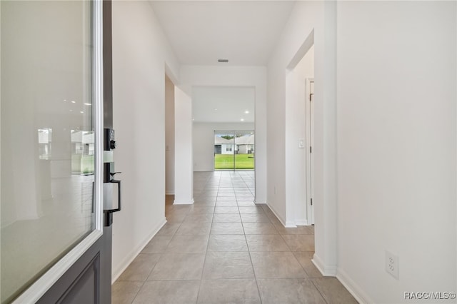 hall with light tile patterned floors