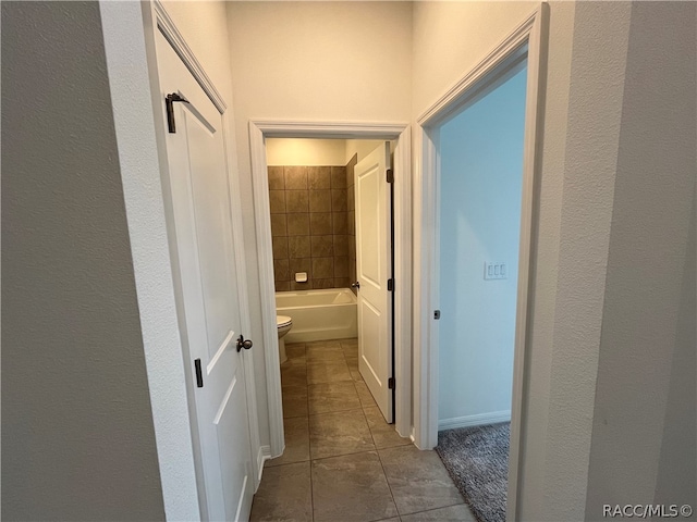 hallway with tile patterned flooring