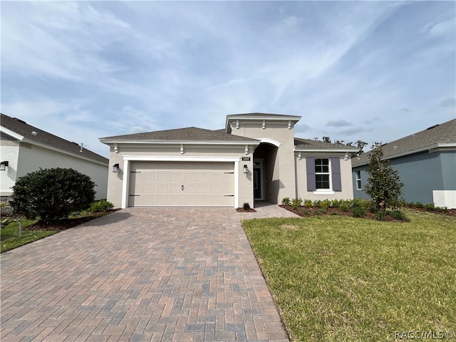 view of front of home featuring a garage and a front lawn