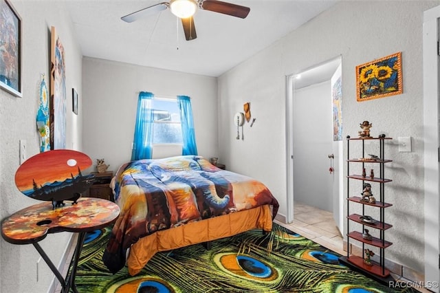 bedroom with ceiling fan and light tile patterned flooring