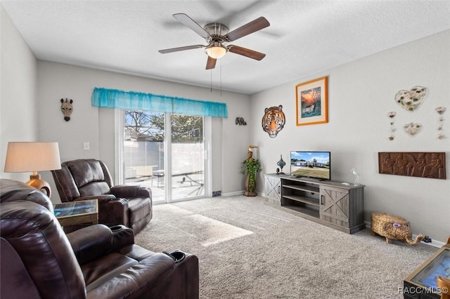 carpeted living room with ceiling fan and a textured ceiling