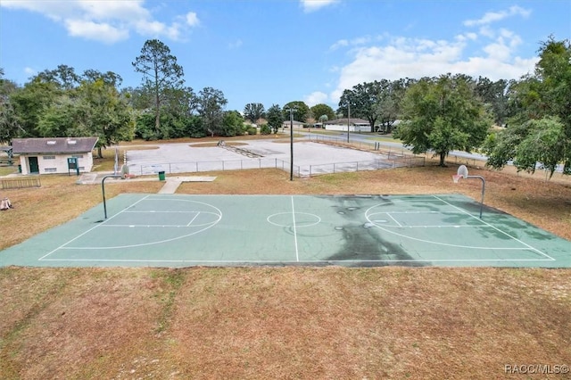 view of basketball court featuring a lawn