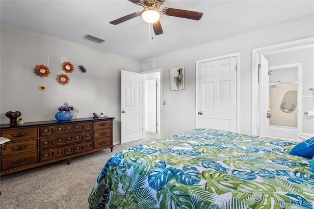 bedroom featuring ceiling fan, light colored carpet, and connected bathroom