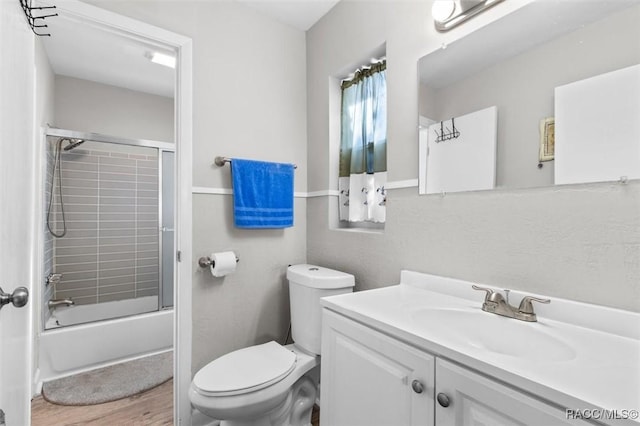 full bathroom with vanity, toilet, and bath / shower combo with glass door