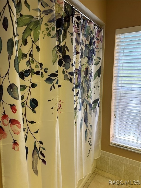 bathroom with tile patterned floors and curtained shower