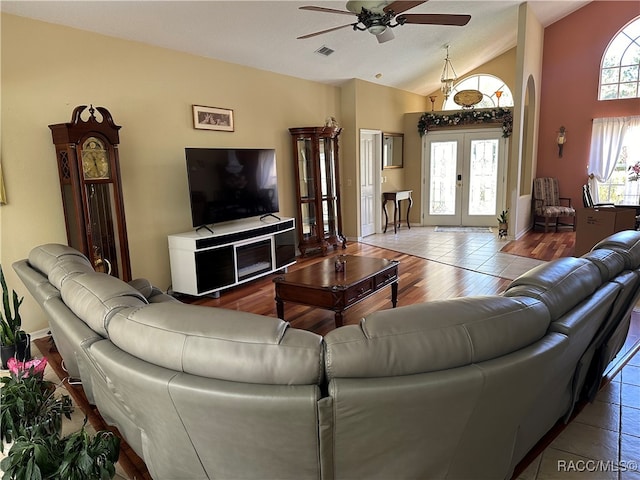 living room with french doors, a textured ceiling, vaulted ceiling, ceiling fan, and hardwood / wood-style flooring