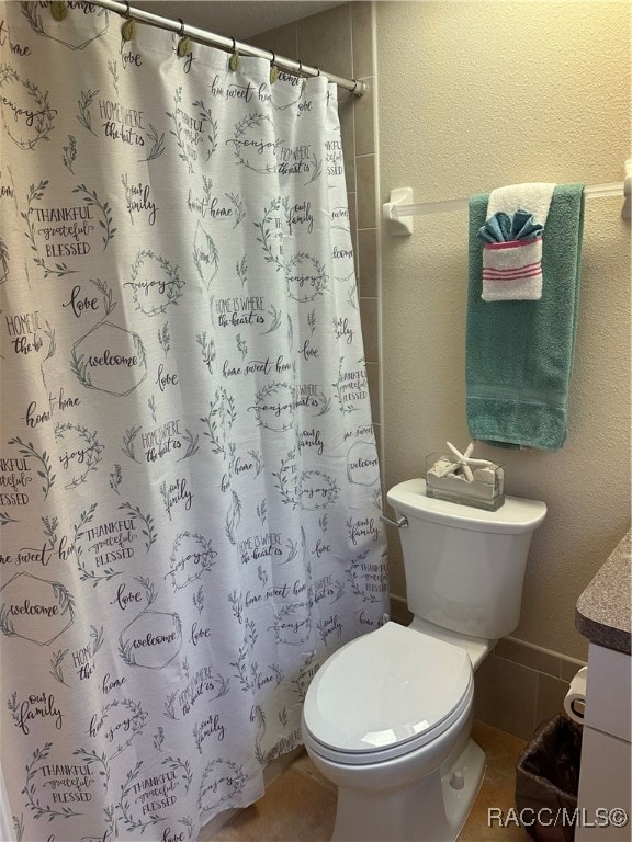 bathroom featuring a shower with curtain, tile patterned flooring, vanity, and toilet