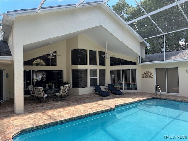 rear view of property featuring a lanai, ceiling fan, and a patio