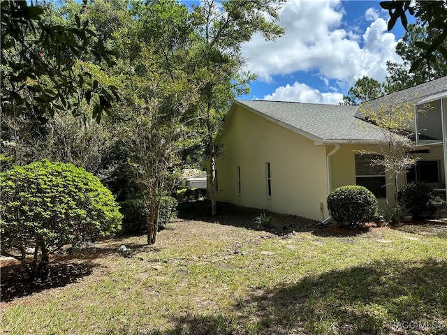 view of property exterior with a yard