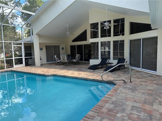 view of pool with a patio, ceiling fan, and a lanai