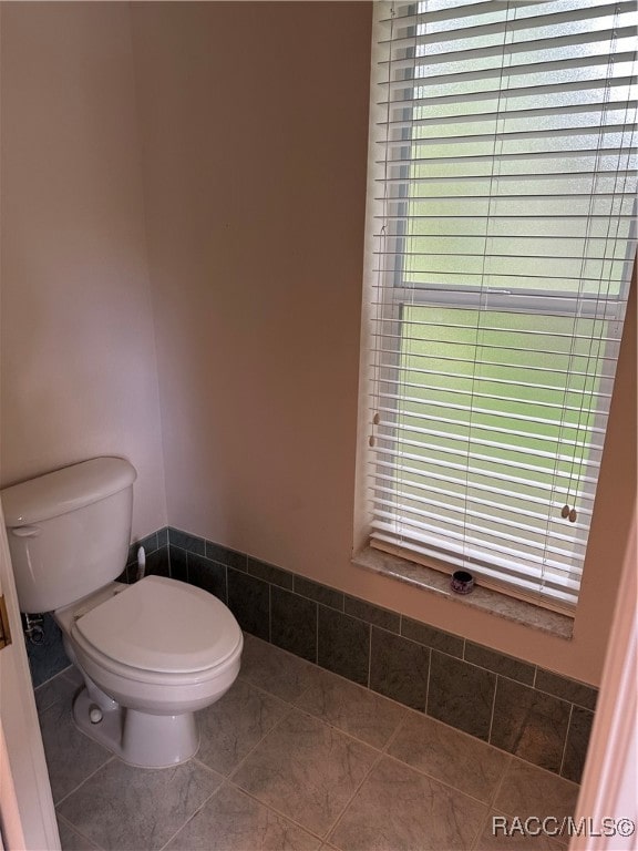 bathroom featuring tile patterned floors and toilet