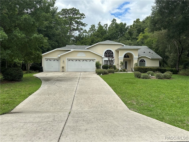 view of front of house with a garage and a front yard