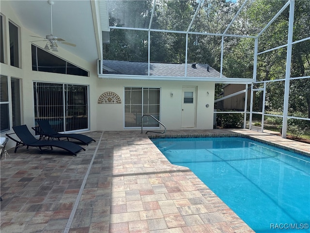 view of pool featuring a lanai, a patio area, and ceiling fan