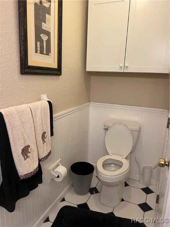 bathroom featuring tile patterned flooring and toilet