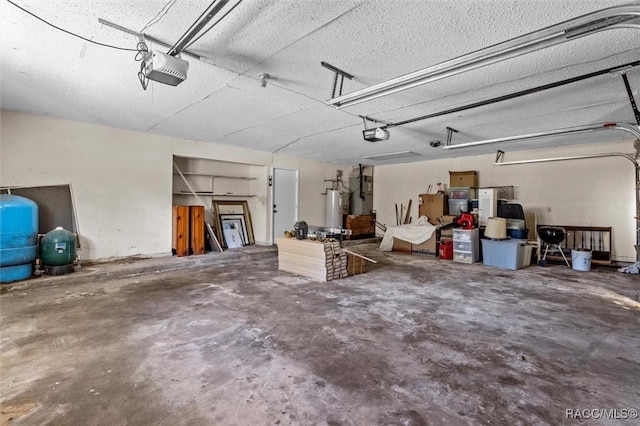 garage featuring a garage door opener and water heater