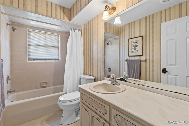 full bathroom featuring tile patterned flooring, shower / bath combo with shower curtain, vanity, and toilet