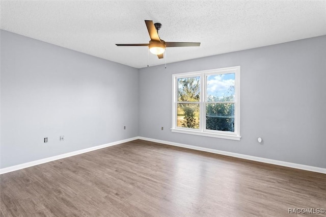 empty room with a textured ceiling, hardwood / wood-style flooring, and ceiling fan