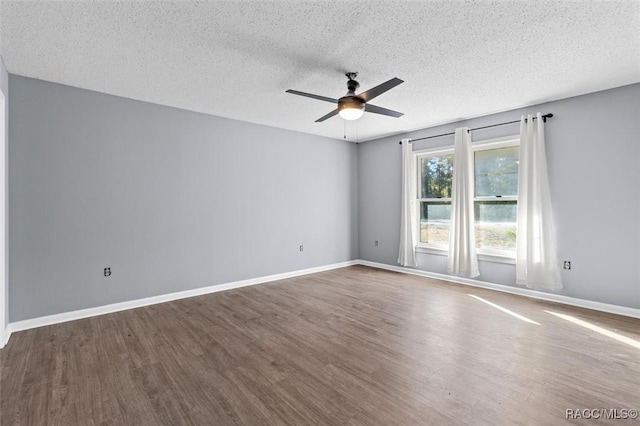 empty room with hardwood / wood-style floors, ceiling fan, and a textured ceiling