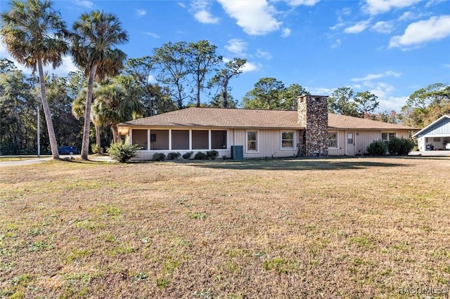 ranch-style home with a sunroom, central AC, and a front lawn