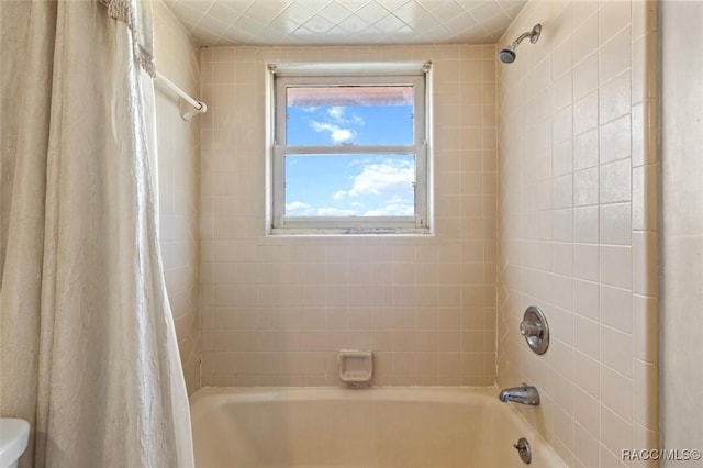 bathroom featuring toilet and shower / bath combo with shower curtain