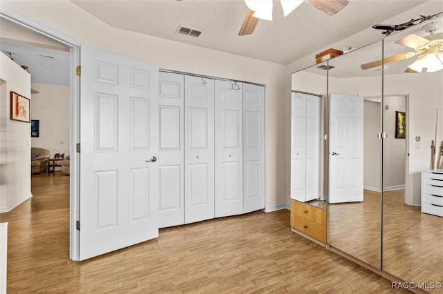 bedroom featuring ceiling fan, wood finished floors, and visible vents