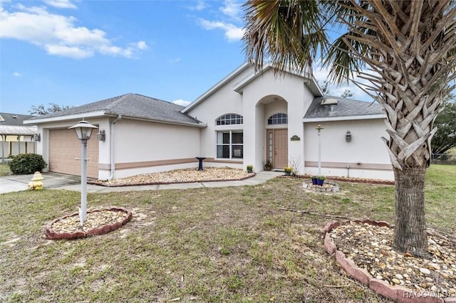 view of front of property featuring a garage, concrete driveway, a front lawn, and stucco siding