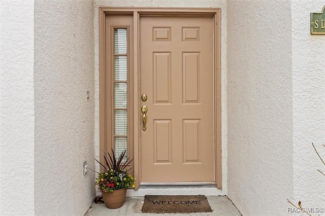 doorway to property with stucco siding