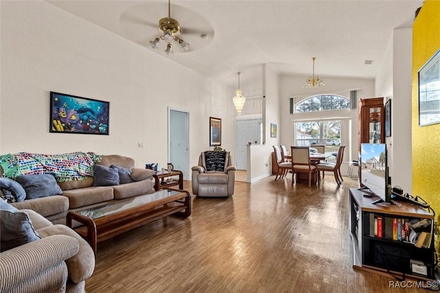 living room featuring high vaulted ceiling, wood finished floors, a ceiling fan, and baseboards